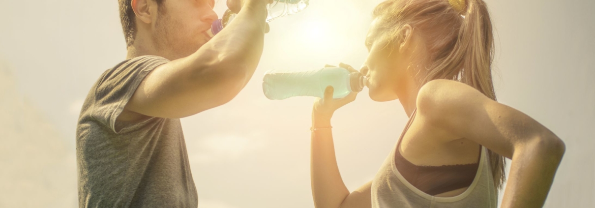 Sports couple drinking water after workout