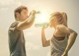 Sports couple drinking water after workout