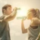 Sports couple drinking water after workout